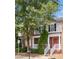 Charming townhome with brick facade, red door, manicured shrubs, and a welcoming front porch at 3262 Cascade Parc Blvd, Atlanta, GA 30311