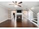 Spacious living room featuring a fireplace, dark hardwood floors, and an open layout to the kitchen at 3262 Cascade Parc Blvd, Atlanta, GA 30311