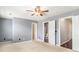 Main bedroom with carpet, windows, ceiling fan, and closet, with an attached bathroom at 3262 Cascade Parc Blvd, Atlanta, GA 30311