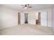 Spacious carpeted main bedroom with a ceiling fan, multiple closets, and bathroom at 3262 Cascade Parc Blvd, Atlanta, GA 30311