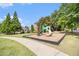 Playground in a community park with lush grass and sidewalk at 3262 Cascade Parc Blvd, Atlanta, GA 30311