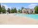 Community pool area with blue water, surrounding lounge chairs and clubhouse at 3262 Cascade Parc Blvd, Atlanta, GA 30311