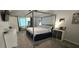 Well-lit bedroom with a canopy bed, carpeting, and a cozy window seating area at 4162 Riverdale Dr, Snellville, GA 30039