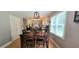 Dining area with a large table, hardwood floors, and bright windows at 4162 Riverdale Dr, Snellville, GA 30039