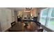 Dining area with a large table, hardwood floors, and natural light from the window at 4162 Riverdale Dr, Snellville, GA 30039