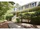Charming home featuring a welcoming front porch, complemented by lush landscaping and well-maintained stairs at 4162 Riverdale Dr, Snellville, GA 30039