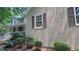Charming home featuring a covered porch, white trim, and brown shutters complemented by professional landscaping at 4162 Riverdale Dr, Snellville, GA 30039