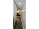 Narrow hallway that leads to a finished basement with hard wood floors, television, eating table and chairs at 4162 Riverdale Dr, Snellville, GA 30039