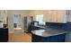 Bright kitchen featuring granite countertops, stainless steel appliances, and white and navy blue cabinetry at 4162 Riverdale Dr, Snellville, GA 30039