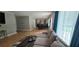Open-concept living room showcases hardwood floors, a gray sofa, and access to a dining area at 4162 Riverdale Dr, Snellville, GA 30039