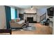 Cozy living room with a brick fireplace, ceiling fan, and stylish blue curtains at 4162 Riverdale Dr, Snellville, GA 30039