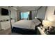 Spacious main bedroom with a canopy bed, a seating nook, and neutral decor at 4162 Riverdale Dr, Snellville, GA 30039