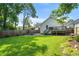 A spacious, grassy backyard featuring a gravel area and mature landscaping at 504 Angier Ne Ave, Atlanta, GA 30308