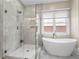 Bathroom features standalone tub, a shower, and gray tiles at 504 Angier Ne Ave, Atlanta, GA 30308