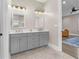 Bathroom features a double vanity with marble countertops and gray cabinets at 504 Angier Ne Ave, Atlanta, GA 30308
