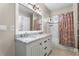 Bathroom with double sink vanity, white cabinets, and tub with shower at 504 Angier Ne Ave, Atlanta, GA 30308