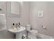Powder room features a pedestal sink, decorative mirror, and a toilet at 504 Angier Ne Ave, Atlanta, GA 30308