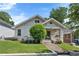 Inviting white brick bungalow with landscaped front yard and covered porch at 504 Angier Ne Ave, Atlanta, GA 30308