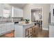 Bright kitchen features white cabinets, granite countertops, and a center island with three stools at 504 Angier Ne Ave, Atlanta, GA 30308