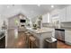 Open concept kitchen with white cabinets, stainless steel appliances, and an island with seating at 504 Angier Ne Ave, Atlanta, GA 30308