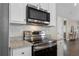Modern kitchen with stainless steel appliances, white cabinets, and granite countertops at 504 Angier Ne Ave, Atlanta, GA 30308