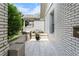 Charming side patio area with gray-toned pavers and white brick accent wall at 504 Angier Ne Ave, Atlanta, GA 30308