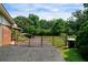 Fenced backyard with an iron gate and gravel, offering security and curb appeal at 81 Laurie Ct, Hiram, GA 30141
