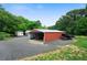 Spacious red metal barn with open bay and attached sheds, providing ample storage and workspace at 81 Laurie Ct, Hiram, GA 30141