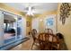 Dining room with sliding glass door to sunroom; features a ceiling fan and tile flooring at 81 Laurie Ct, Hiram, GA 30141
