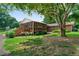 Exterior of the home showcasing a screened porch, wooden steps, and well-maintained landscaping at 81 Laurie Ct, Hiram, GA 30141