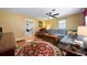 Cozy living room with hardwood floors, a comfortable sectional couch, and a ceiling fan at 81 Laurie Ct, Hiram, GA 30141