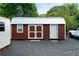Functional brown metal shed with white doors and trim, ideal for storing tools and equipment at 81 Laurie Ct, Hiram, GA 30141