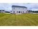 Spacious backyard featuring a patio and green lawn at 105 Marchmont Dr, Locust Grove, GA 30248