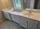 Bathroom with white cabinets and dual vanity with granite countertop at 105 Marchmont Dr, Locust Grove, GA 30248