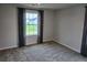 Bright bedroom with a window, carpet, and stylish curtains, creating a cozy atmosphere at 105 Marchmont Dr, Locust Grove, GA 30248