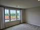 Bedroom showcasing three windows offering natural light and a view of the outside at 105 Marchmont Dr, Locust Grove, GA 30248
