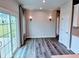 The dining area includes modern lighting, sliding glass doors to the backyard and neutral decor at 105 Marchmont Dr, Locust Grove, GA 30248