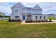 Beautiful two-story home with a well-kept lawn and blue door at 105 Marchmont Dr, Locust Grove, GA 30248