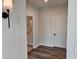 The hallway features a door to the bathroom and contemporary lighting fixtures at 105 Marchmont Dr, Locust Grove, GA 30248