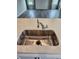 The kitchen features a stainless steel sink and faucet, complemented by elegant stone countertops at 105 Marchmont Dr, Locust Grove, GA 30248