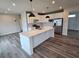 Stylish kitchen features a large island, stainless steel appliances, and white cabinetry for a modern look at 105 Marchmont Dr, Locust Grove, GA 30248