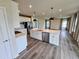 Open-concept kitchen featuring a central island, stainless steel appliances, and seamlessly integrates with living areas at 105 Marchmont Dr, Locust Grove, GA 30248
