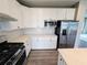 Well-equipped kitchen with modern appliances, white cabinetry, and ample counter space for cooking and prepping at 105 Marchmont Dr, Locust Grove, GA 30248