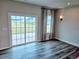 The living room features a sliding glass door to the back yard and contemporary window treatments at 105 Marchmont Dr, Locust Grove, GA 30248