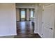 Inviting living room with plenty of natural light and hardwood flooring, ready to be enjoyed at 105 Marchmont Dr, Locust Grove, GA 30248