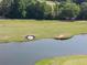 Picturesque aerial shot of a golf course featuring a water hazard and manicured greens at 14 Augusta Way, Hiram, GA 30141
