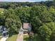 Aerial view of a two-story home surrounded by lush green trees in a landscaped lawn at 14 Augusta Way, Hiram, GA 30141