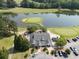 Overhead shot of the golf course and clubhouse surrounded by water, parking, and green space at 14 Augusta Way, Hiram, GA 30141