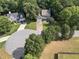 Aerial view of homes nestled in lush, green trees with a landscaped lawn at 14 Augusta Way, Hiram, GA 30141