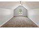 Finished attic room with neutral carpet, sloped ceilings, and a bright window at 14 Augusta Way, Hiram, GA 30141